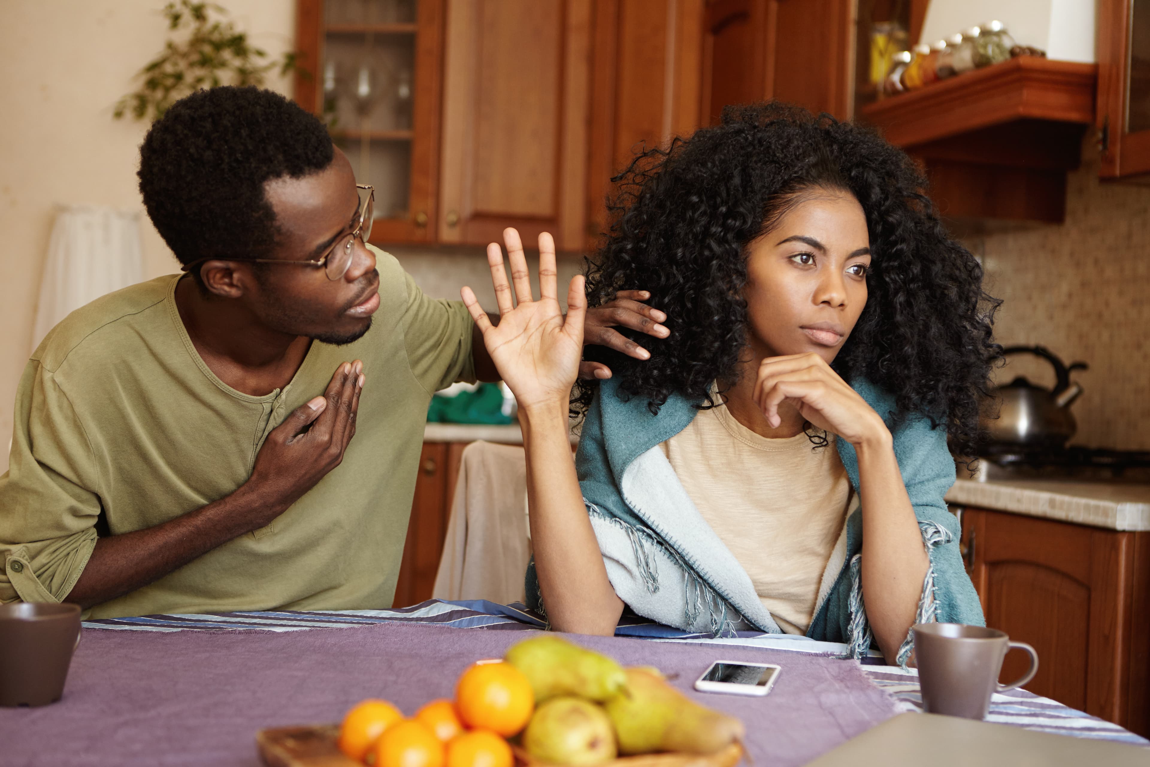 Couple in a tense conversation at a kitchen table