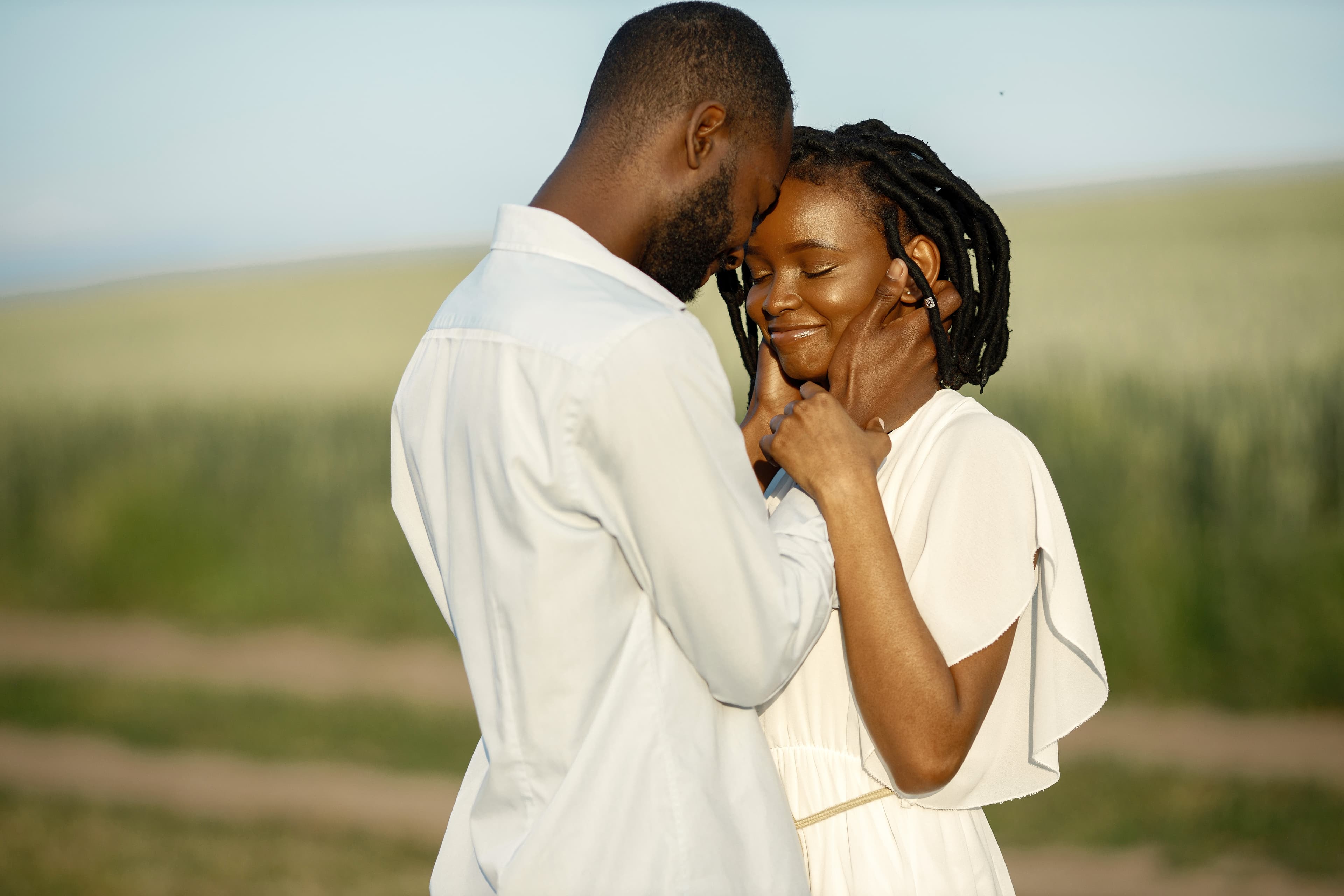 Couple embracing in a field